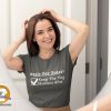 Woman preparing for her day wearing a t-shirt with "Goals For Today: Keep Tiny Humans Alive"