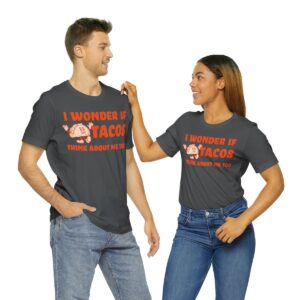 man and a woman wearing shirts that say "I wonder if tacos think about me too."